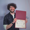 Student Julian Rivera with an award certificate